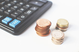 calculator with piles of change